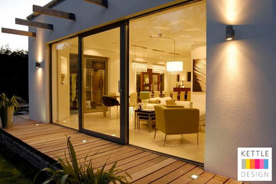Medium sized and white contemporary house exterior in Other with stone cladding.
