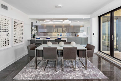 Inspiration for a contemporary marble floor and gray floor kitchen/dining room combo remodel in Miami with white walls