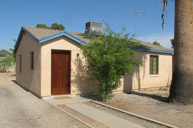 Inspiration for a mid-sized southwestern beige one-story stucco gable roof remodel in Phoenix