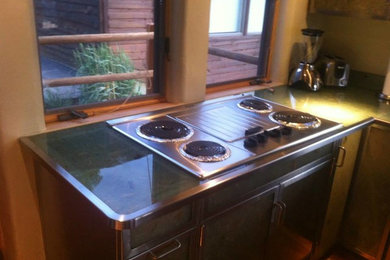 Kitchen - mid-sized transitional u-shaped medium tone wood floor and brown floor kitchen idea in Other with a double-bowl sink, stainless steel appliances and a peninsula