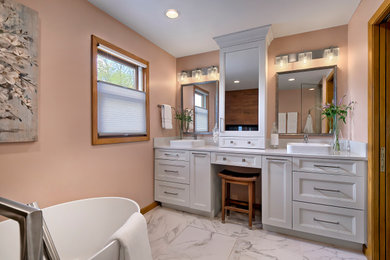 Example of a mid-sized trendy master porcelain tile, gray floor and double-sink freestanding bathtub design in Chicago with recessed-panel cabinets, white cabinets, orange walls, a vessel sink, quartz countertops, white countertops and a built-in vanity