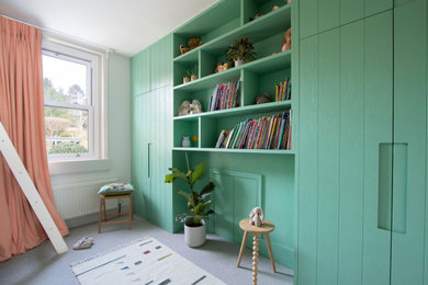 Photo of a small contemporary children’s room for girls in Other with white walls, carpet and a feature wall.