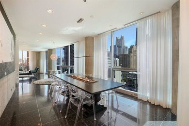 Example of a large trendy marble floor and black floor great room design in Chicago with beige walls and no fireplace