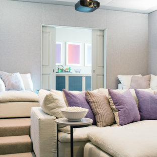 Inspiration for a traditional enclosed home cinema in Los Angeles with grey walls, carpet, a projector screen and grey floors.