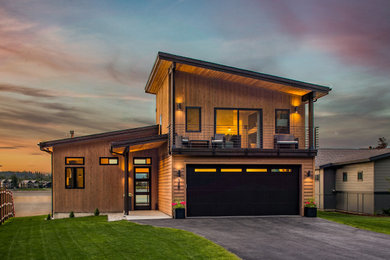 Inspiration for a mid-sized modern brown two-story wood house exterior remodel in Seattle with a mixed material roof