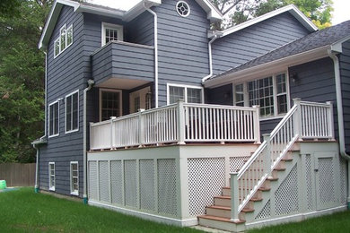 Large elegant blue three-story wood exterior home photo in Boston with a shingle roof