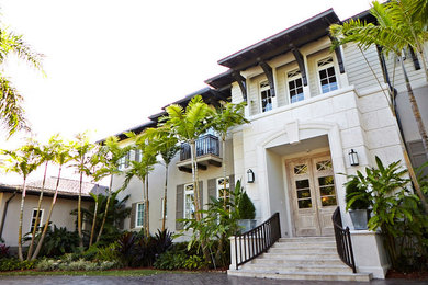 Example of a huge minimalist white two-story concrete exterior home design in Miami