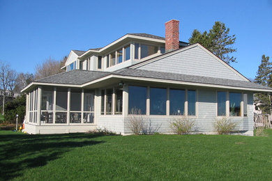 Example of a trendy wood house exterior design