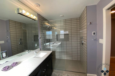 Example of a trendy master ceramic tile and double-sink bathroom design in Denver with black cabinets, purple walls, a drop-in sink, quartz countertops and white countertops