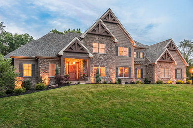 Large mountain style brown two-story mixed siding exterior home photo in Other with a shingle roof
