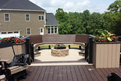 Deck - large modern backyard deck idea in Other with a fire pit and no cover