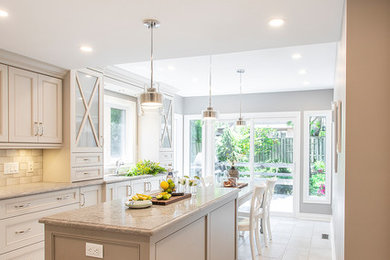 Inspiration for a mid-sized timeless u-shaped porcelain tile and beige floor eat-in kitchen remodel in Toronto with an undermount sink, recessed-panel cabinets, beige cabinets, granite countertops, beige backsplash, ceramic backsplash, paneled appliances, an island and beige countertops