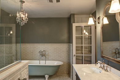 Claw-foot bathtub - mid-sized contemporary master beige tile and ceramic tile claw-foot bathtub idea in Denver with an undermount sink, shaker cabinets, dark wood cabinets, marble countertops and multicolored walls