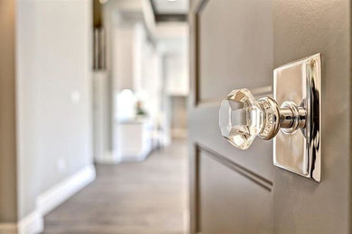 Hallway - large transitional medium tone wood floor hallway idea in Los Angeles with gray walls