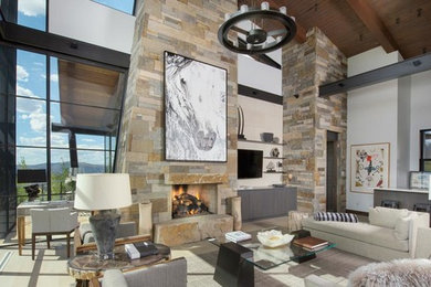 Design ideas for an expansive transitional open concept living room in Denver with white walls, light hardwood floors, a standard fireplace, a stone fireplace surround and a wall-mounted tv.