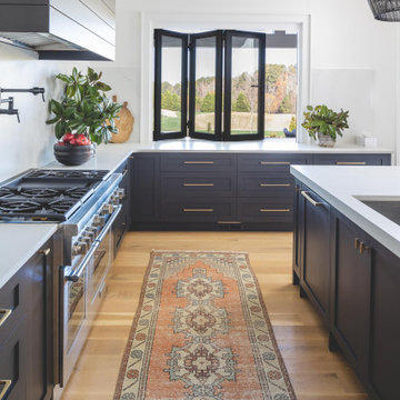 Custom Kitchen with Dark Island, Light Wood Cabinetry & Statement Pendants