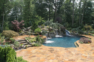 Island style pool photo in New York