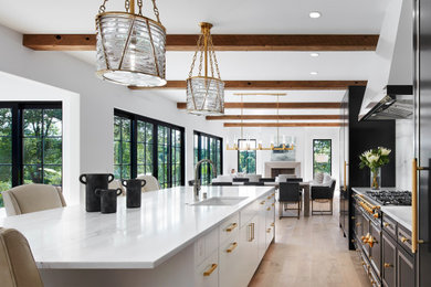 Inspiration for a contemporary light wood floor and exposed beam eat-in kitchen remodel in Minneapolis with an undermount sink, marble countertops, white backsplash, marble backsplash, paneled appliances, an island and white countertops