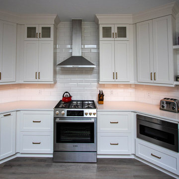 3 Finishes on Kitchen Cabinetry with Galley Workstation in Island and Wine Bar