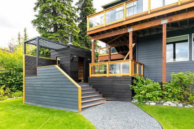 Example of a mid-sized trendy gray split-level mixed siding house exterior design in Other