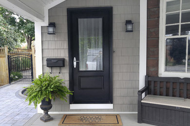 Inspiration for a transitional concrete paver front porch remodel in Ottawa