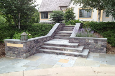 Design ideas for an expansive arts and crafts front yard garden in Minneapolis with a garden path and natural stone pavers.