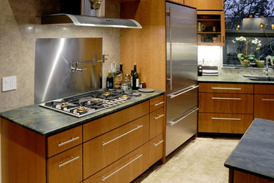 Inspiration for a large contemporary galley travertine floor eat-in kitchen remodel in Phoenix with an undermount sink, flat-panel cabinets, medium tone wood cabinets, marble countertops, green backsplash, mosaic tile backsplash, stainless steel appliances and an island