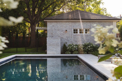 Example of a mid-sized classic backyard concrete paver and rectangular pool landscaping design in St Louis
