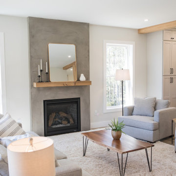 Open Concept Living Room with Concrete Looking Plaster Fireplace.