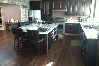 Example of a dark wood floor kitchen design in Chicago with shaker cabinets, dark wood cabinets and granite countertops