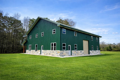 Large industrial green two-story mixed siding exterior home idea in Houston with a metal roof