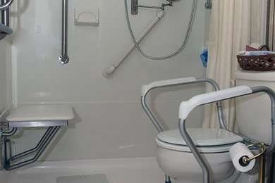 Inspiration for a ceramic tile bathroom remodel in New York with a two-piece toilet and white walls