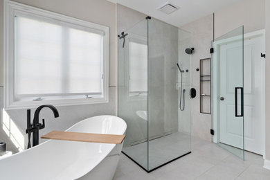 Bathroom - large transitional master gray tile and porcelain tile porcelain tile, gray floor, double-sink and wainscoting bathroom idea in Columbus with beaded inset cabinets, medium tone wood cabinets, a two-piece toilet, gray walls, an undermount sink, quartz countertops, a hinged shower door, beige countertops, a niche and a built-in vanity