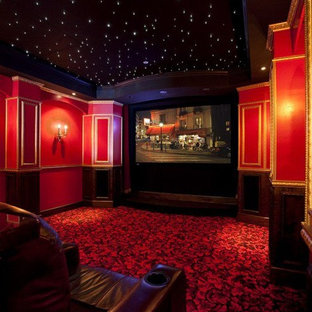 Inspiration for a home cinema in Providence with red walls and carpet.