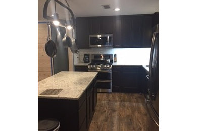 Inspiration for a mid-sized timeless l-shaped vinyl floor open concept kitchen remodel in Other with a double-bowl sink, dark wood cabinets, granite countertops, white backsplash, subway tile backsplash, stainless steel appliances and an island