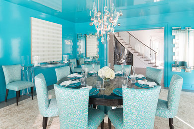 This is an example of a contemporary dining room in New York with blue walls, dark hardwood floors and brown floor.