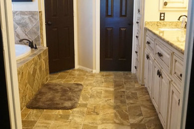 Mid-sized elegant master beige tile and porcelain tile porcelain tile bathroom photo in Houston with raised-panel cabinets, white cabinets, beige walls, an undermount sink and granite countertops