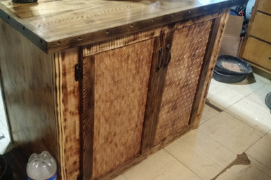 Example of a small country galley kitchen pantry design in Other with flat-panel cabinets, medium tone wood cabinets, wood countertops, an island and brown countertops