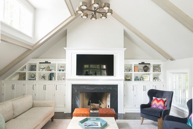 Transitional living room in New York with white walls, a standard fireplace, a wall-mounted tv and grey floor.