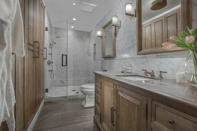 Alcove shower - mid-sized eclectic 3/4 brown tile and stone tile limestone floor alcove shower idea in New York with furniture-like cabinets, light wood cabinets, a two-piece toilet, white walls and an undermount sink