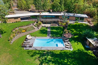 This is an example of a large midcentury house exterior in Seattle.