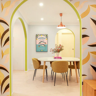 Photo of a small eclectic dining room in Sydney with blue walls and vinyl floors.