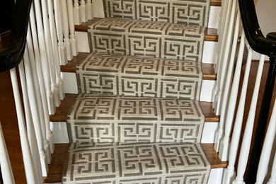 Example of a classic staircase design in Charlotte with carpeted risers