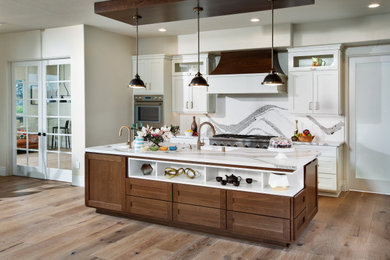 Inspiration for a large transitional l-shaped light wood floor and brown floor eat-in kitchen remodel in Sacramento with an undermount sink, shaker cabinets, white cabinets, quartz countertops, white backsplash, quartz backsplash, stainless steel appliances, an island and white countertops