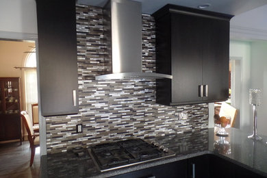 Mid-sized trendy u-shaped porcelain tile open concept kitchen photo in Nashville with a single-bowl sink, flat-panel cabinets, dark wood cabinets, quartz countertops, multicolored backsplash, metal backsplash, stainless steel appliances and an island