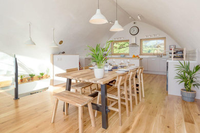 Inspiration for an eclectic light wood floor and vaulted ceiling dining room remodel in Portland Maine