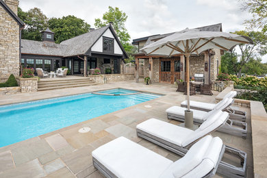 Elegant backyard stone pool photo in Minneapolis