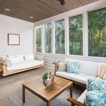 Sunroom with Hanging Daybed Swing and Shiplap Walls