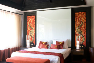Design ideas for a mid-sized asian guest bedroom in Other with beige walls, dark hardwood floors and black floor.