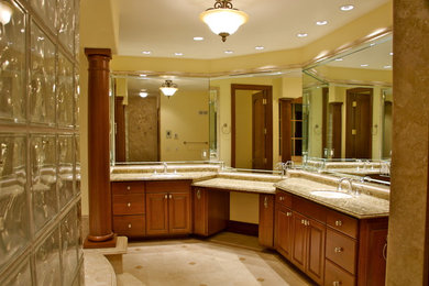 Mid-sized traditional master bathroom in San Francisco with raised-panel cabinets, medium wood cabinets, yellow walls, porcelain floors, an undermount sink and granite benchtops.